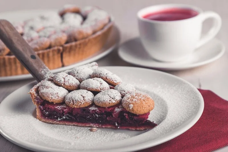 Tarte aux framboises avec une tasse de café torréfaction claire